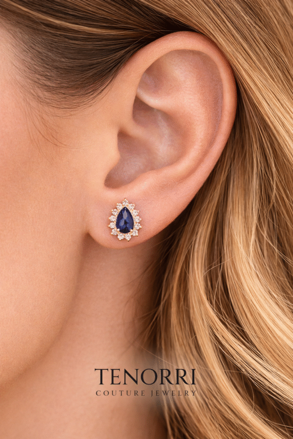 tenorri-sapphire-earrings-model.jpg Elegant woman wearing TENORRI sapphire halo stud earrings
